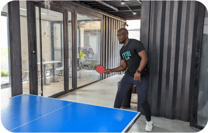 a man playing ping pong outdoor